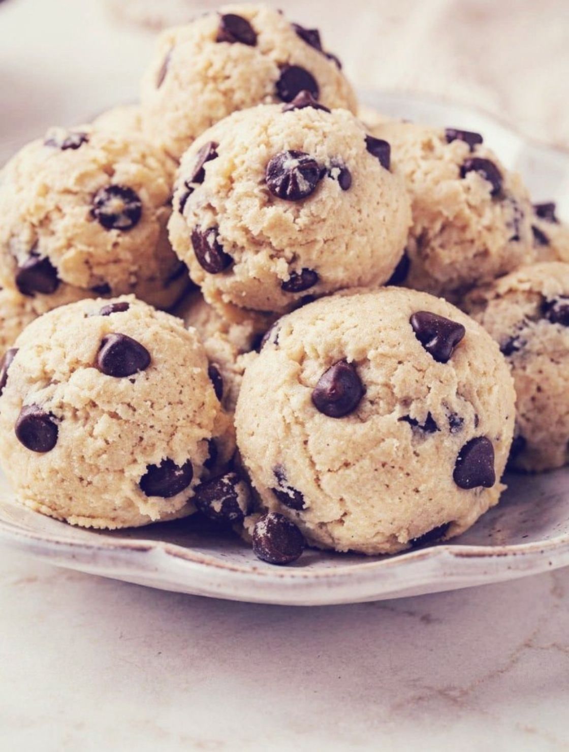 Cottage Cheese Cookie Dough. high protein no bake dessert bites on ivory plate