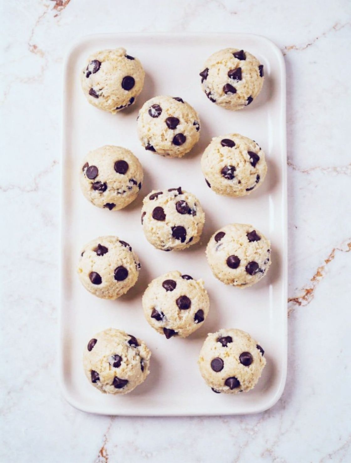 Cottage Cheese Cookie Dough. high protein no bake dessert bites on ivory plate