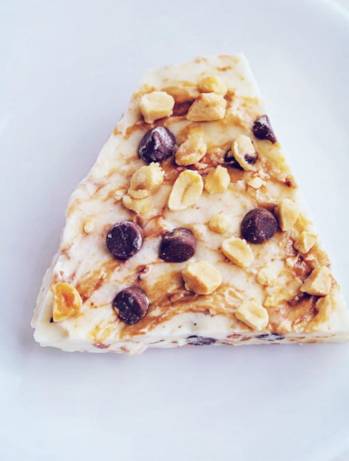 A single piece of high protein Keto Peanut Butter Yogurt Bark ready to eat.